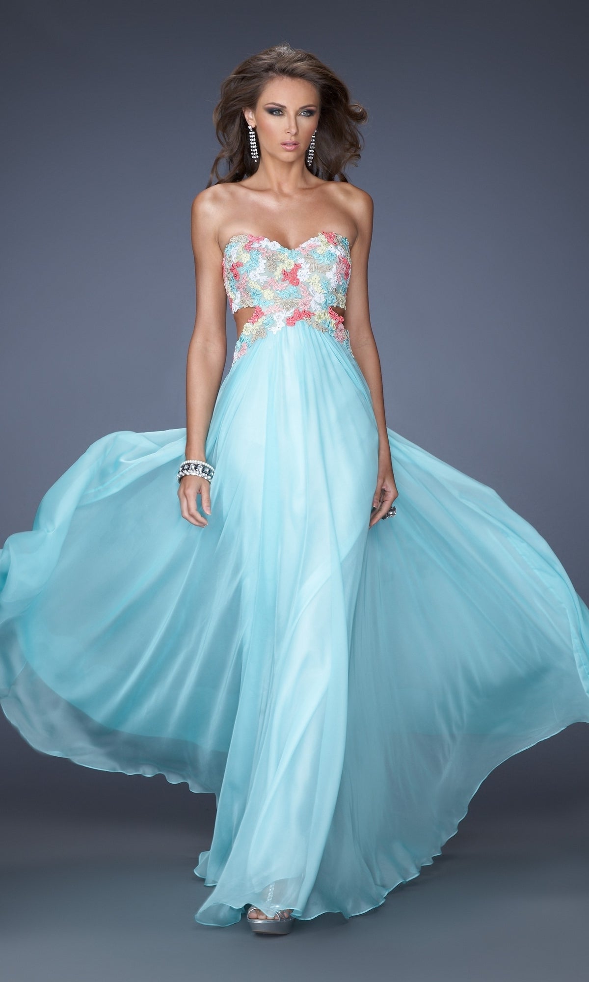 A woman poses against a plain gray background wearing the La Femme Multicolor-Lace Chiffon Prom Dress 20059, featuring a strapless light blue design with floral lace embroidery on the bodice.