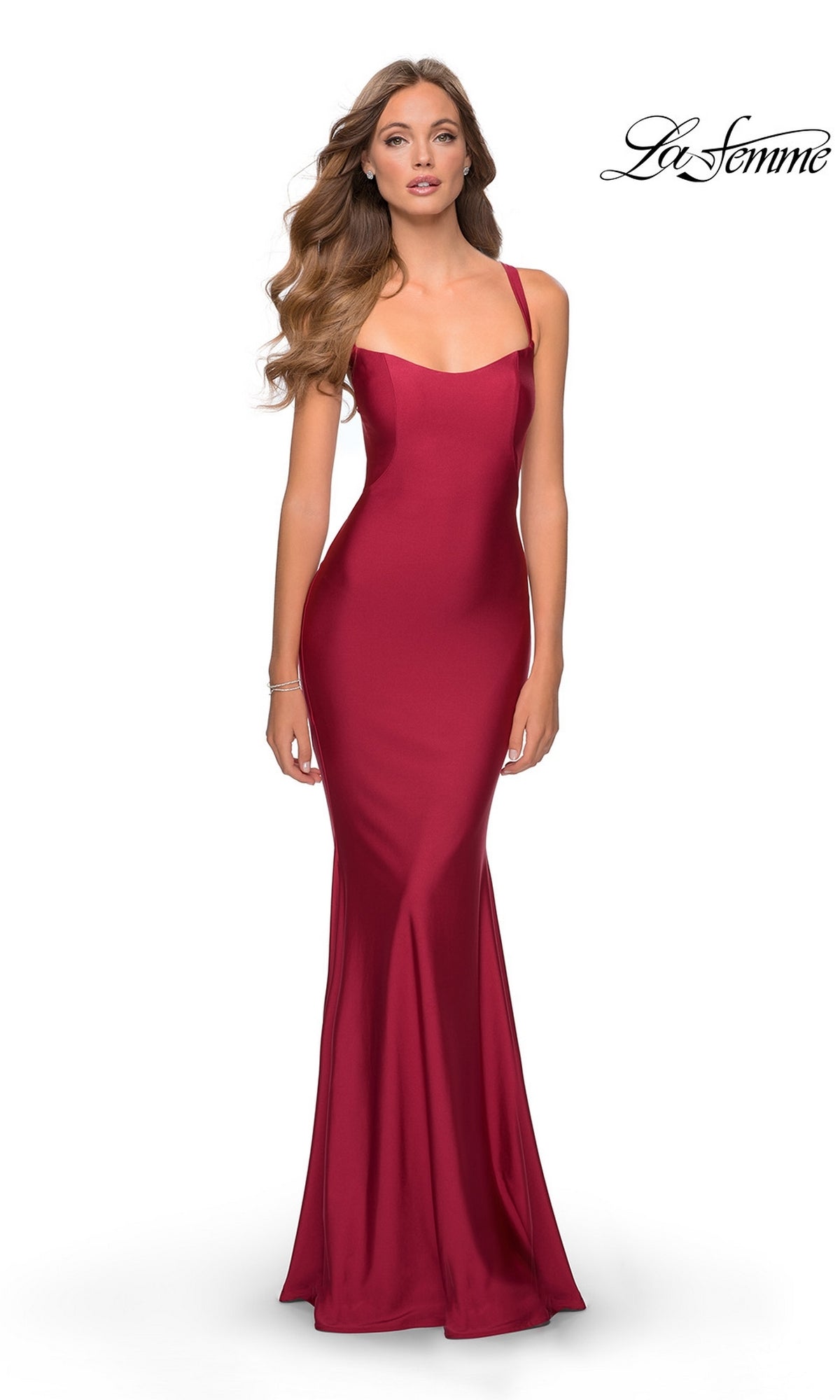 A woman models the La Femme Simple Long Prom Dress 28568 in burgundyâ€”a fitted, floor-length, sleeveless gown with thin straps and an open backâ€”against a white background. The "La Femme" logo is in the top right corner. Ideal for formal events.