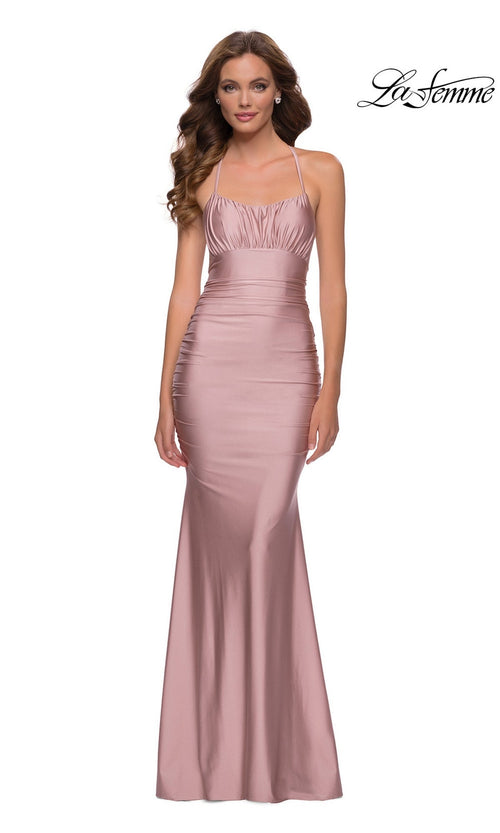 Woman in a sleeveless blush pink La Femme Ruched-Bust Long Prom Dress 29873 with thin straps, slight ruching at the bodice, and a fitted silhouette. "La Femme" logo appears in the top right corner to accent this elegant look.