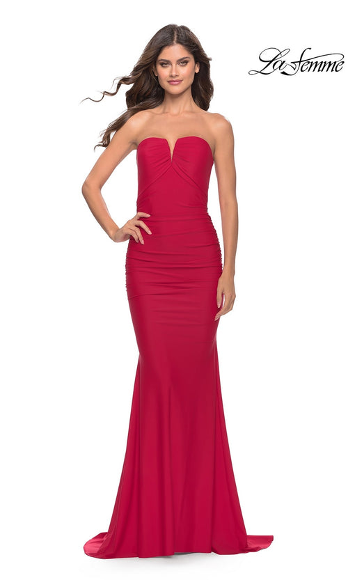 A woman models the La Femme Classic Strapless Tight Prom Dress 31226â€”fitted, floor-length, and red with a slight sweetheart necklineâ€”against a white background.