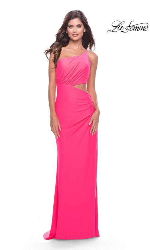 A woman models the La Femme Long Prom Dress 31443, a bright pink fitted gown with a side cutout, standing against a white background. The "La Femme" logo is visible in the top right corner.