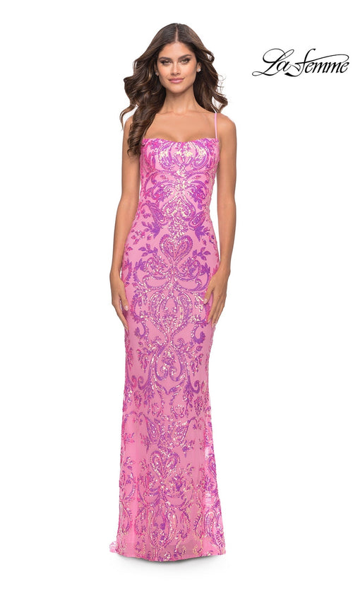 A woman in a neon pink, open-back long sequin prom dress (La Femme 31521) with a fitted silhouette and intricate pattern stands against a white background. The La Femme logo appears in the top right corner.