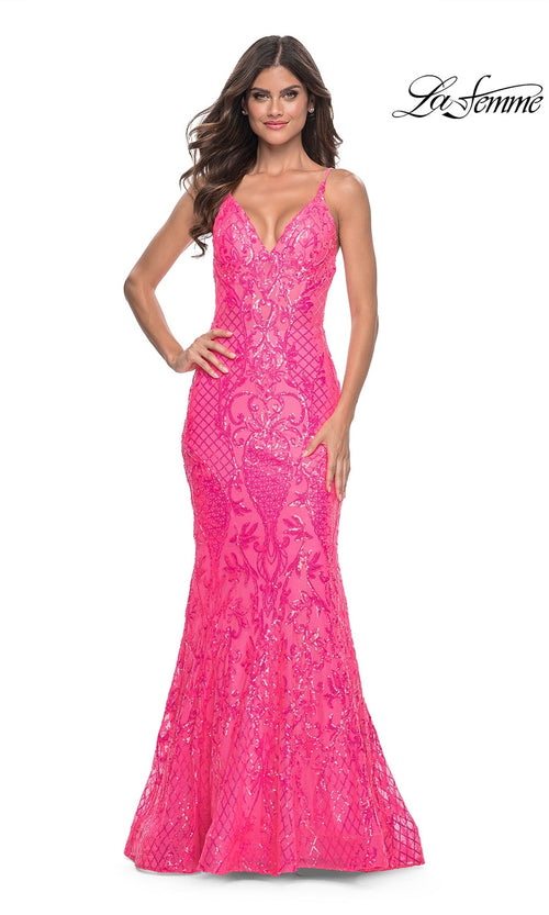 Woman wearing the La Femme Long Sequin Mermaid Prom Dress 32337â€”fitted, bright pink with thin straps and sequin detailingâ€”standing against a white background.
