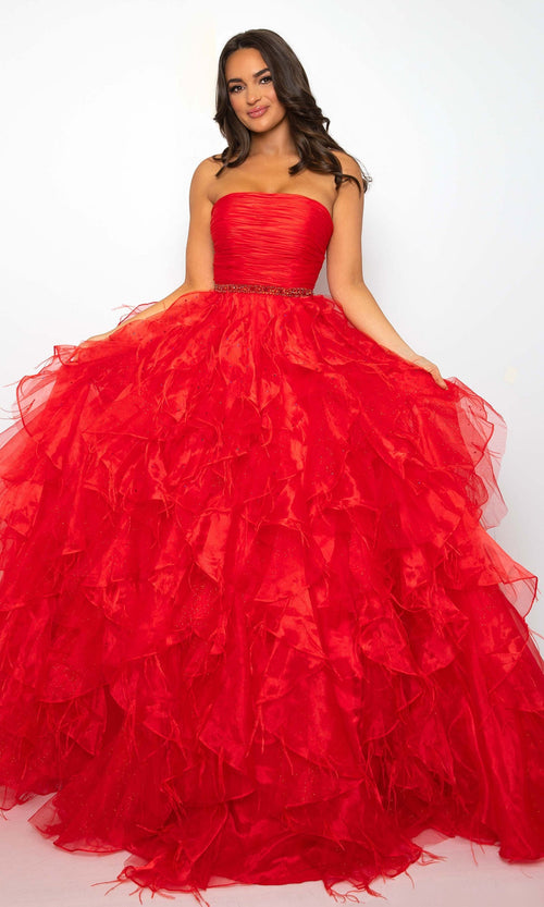 A woman models the Ava Presley 39555 Strapless Ruffle Prom Gown in bright red, showcasing its voluminous ruffled A-line skirt, standing against a plain white background.