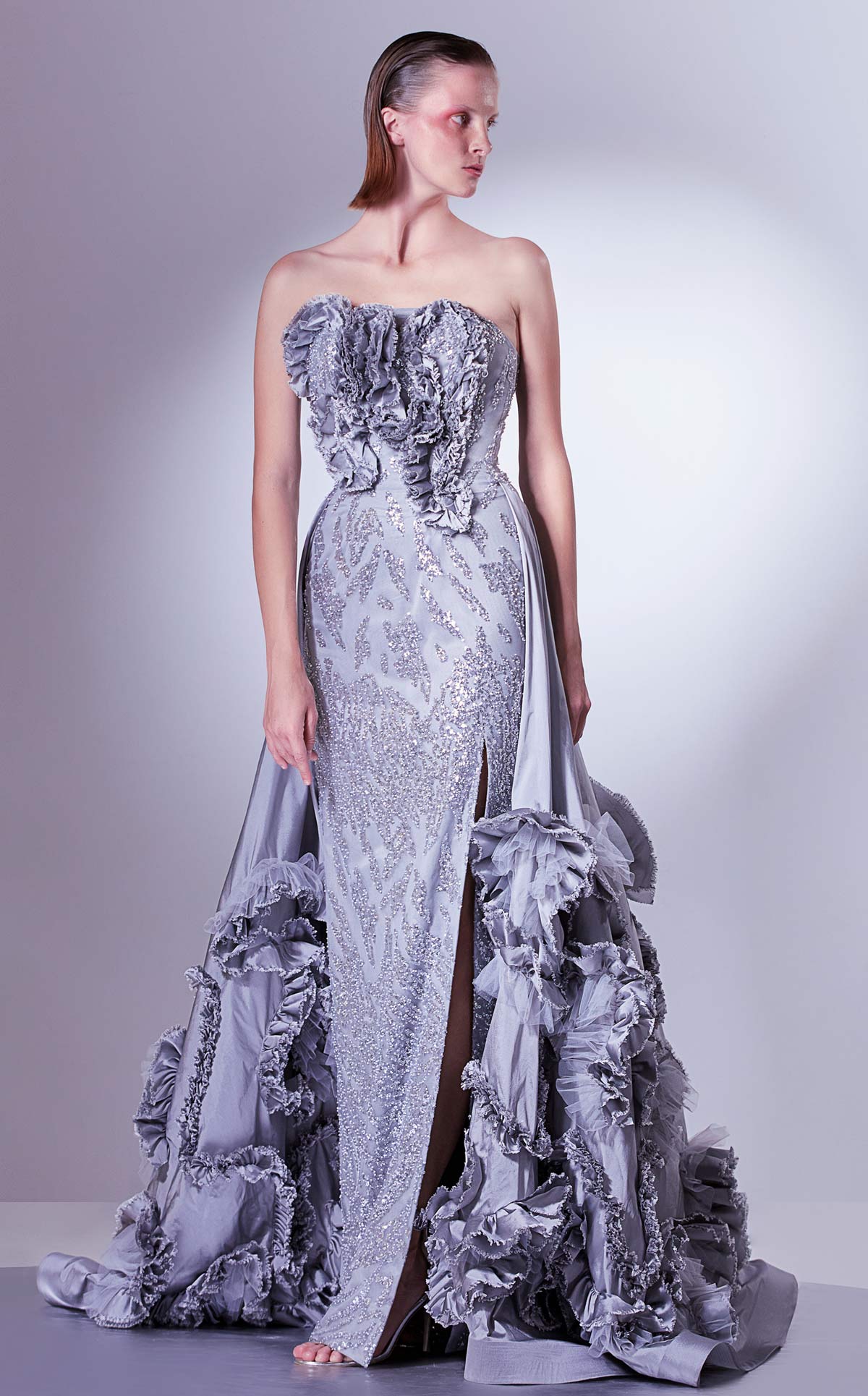 Gaby Charbachi G1330 Silver Strapless Sequined Gown with Overskirt by MNM Couture