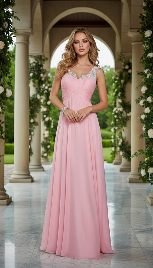 A woman in the Sheer-Back Long A-Line Prom Dress: La Femme 21130, with jeweled straps, stands in a marble colonnade garden filled with greenery and white flowersâ€”her elegant gown perfect for any special occasion.