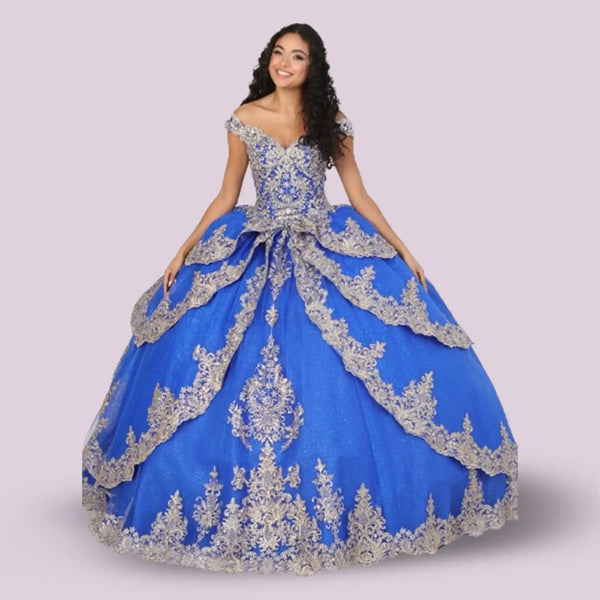 Royal blue ball gown with ornate silver lace appliqués and an off-shoulder neckline.